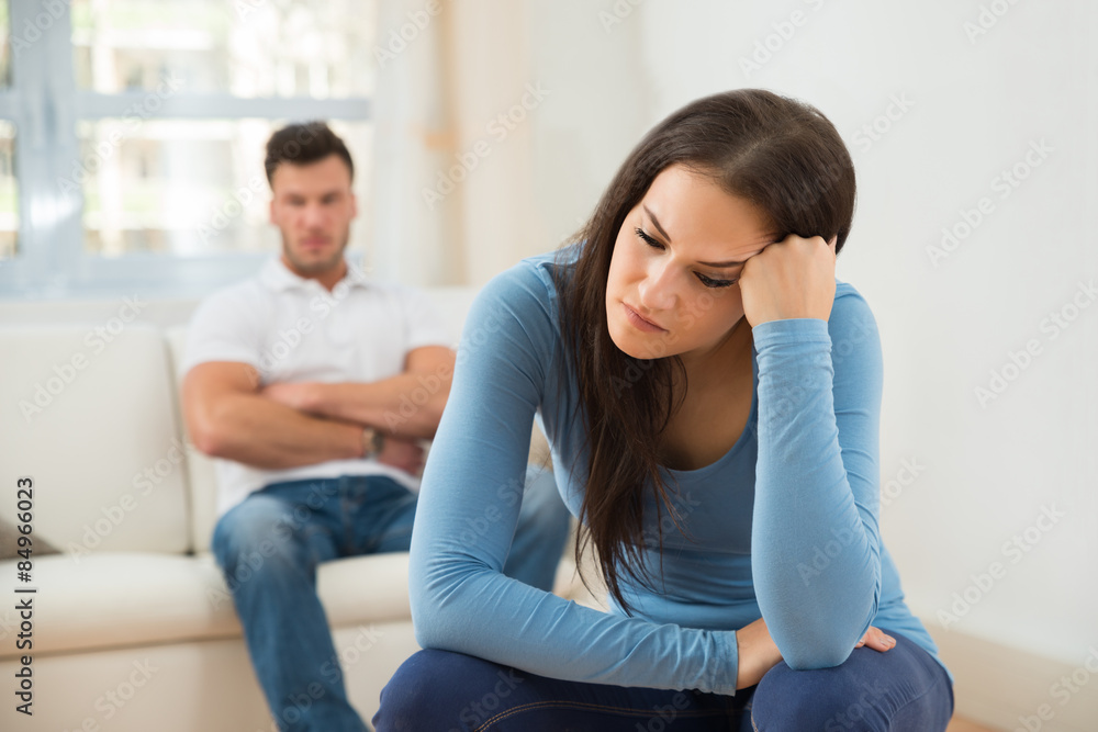 Defocused Man In Front Of Sad Young Woman Defocused Man In Front Of Sad Young Woman