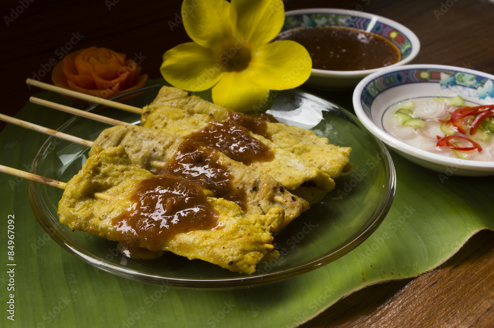 Pork satay with delicious peanut sauce, ketupat, onion and cucum Pork satay with delicious peanut sauce, ketupat, onion and cucum