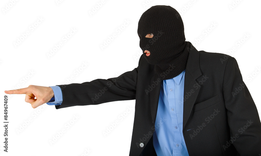 Thief in black mask in suit pointing with his finger