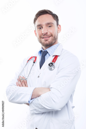 Handsome doctor standing on white background 