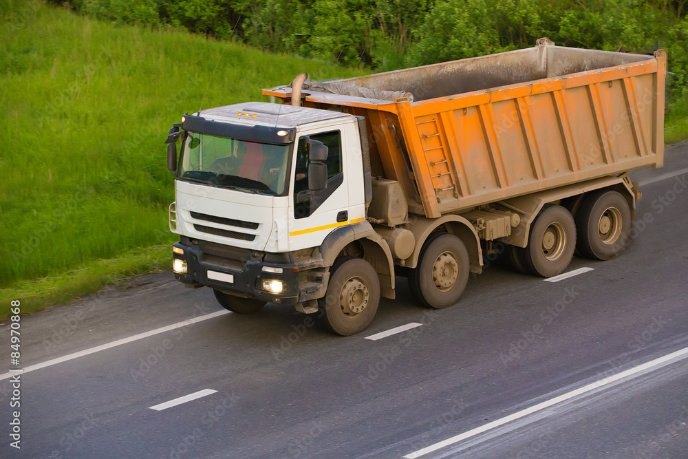 dump truck goes on country highway