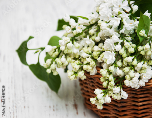 Basket with white lilac flowers