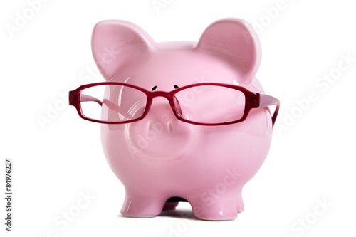 Pink piggy or piggybank one single pink wearing glasses retirement old age saving plan isolated on white background photo