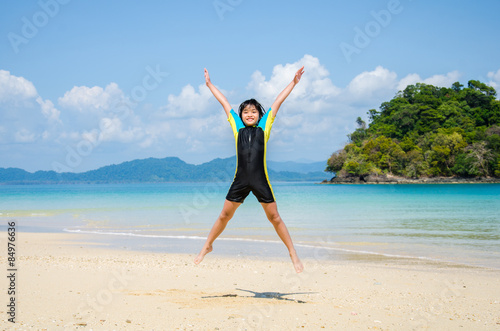 Girl jumping on the beach..