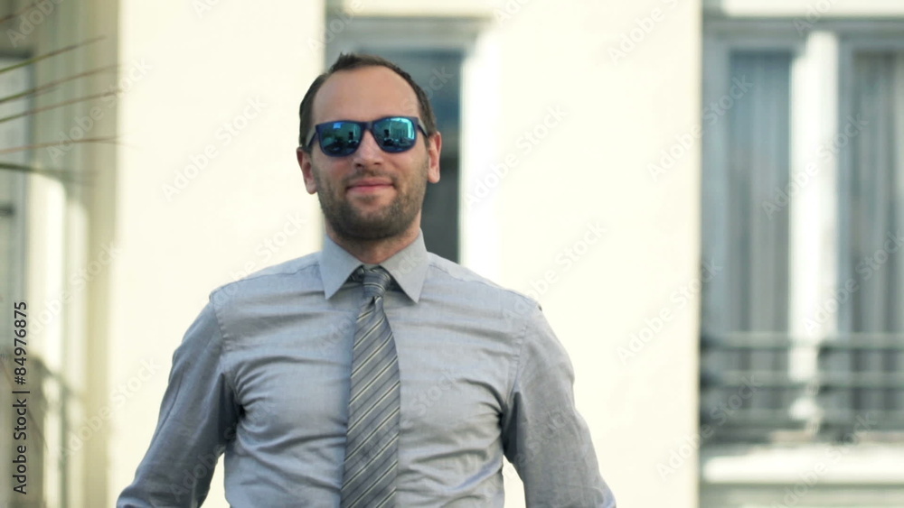 Portrait of smiling, handsome businessman standing on balcony
Portrait of smiling, handsome businessman standing on balcony
