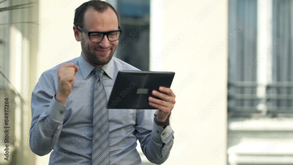 Happy, successful businessman with tablet computer standing on balcony
Happy, successful businessman with tablet computer standing on balcony