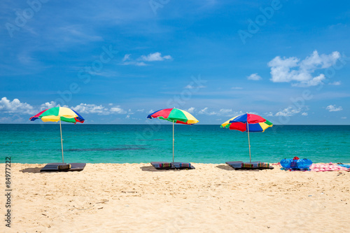 beach umbrella and ring on beach with blue sky, phuket thailand © powerbeephoto
