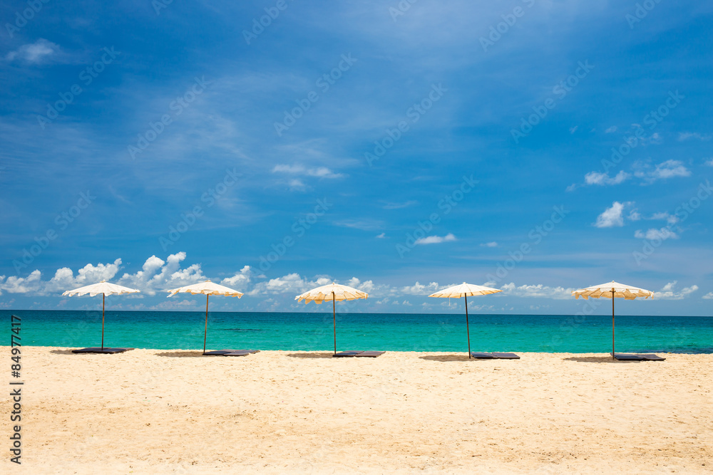 beach umbrella on beach with blue sky, phuket thailand beach umbrella on beach with blue sky, phuket thailand