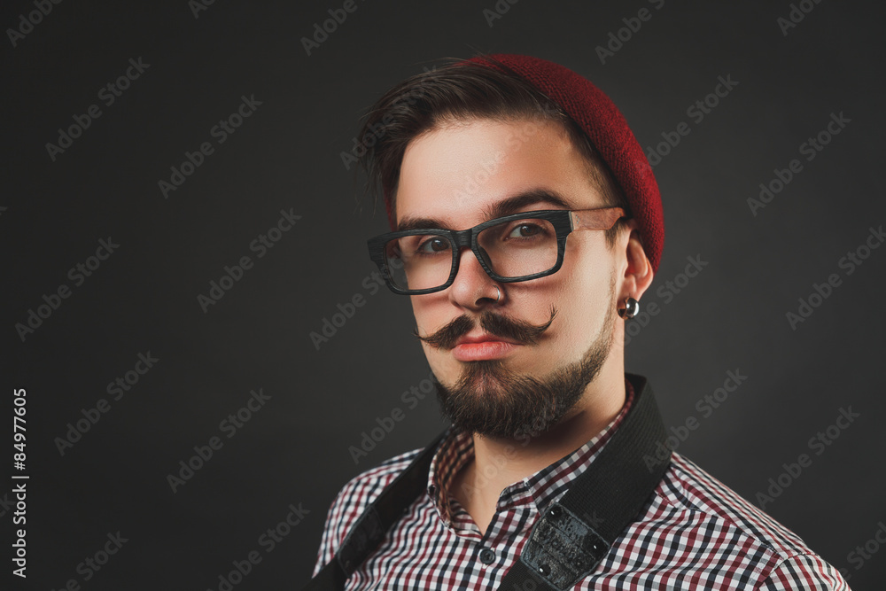 Fototapeta premium handsome guy with beard holding vintage camera