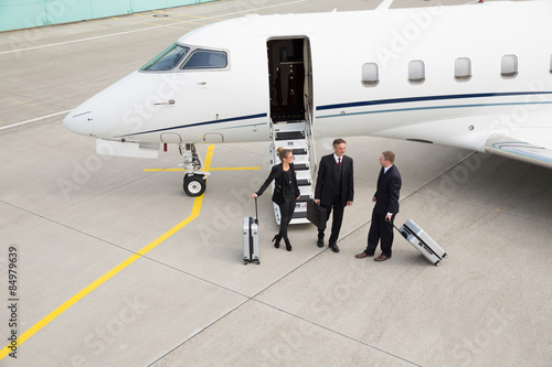executive manager in front of corporate jet
