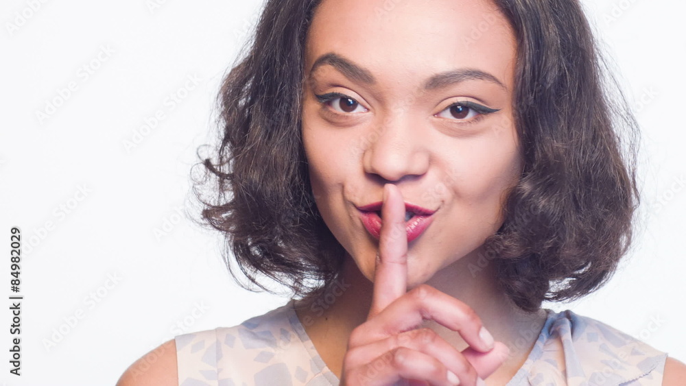 Nice girl with index finger on her mouth Nice girl with index finger on her mouth