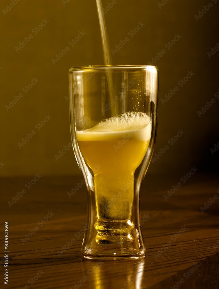 light fresh beer in glasses, on a wooden table light fresh beer in glasses, on a wooden table