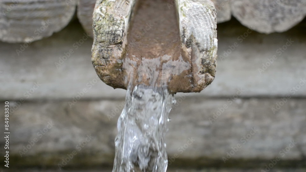 Water flowing out of a wooden funnel from a natural spring
Water flowing out of a wooden funnel from a natural spring