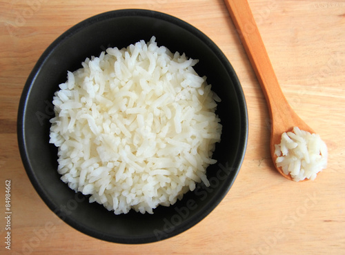 bowl full of rice on wood background