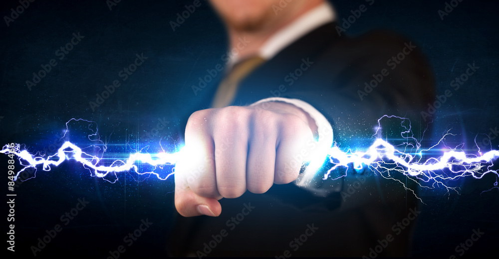 Business man holding electricity light bolt in his hands Business man holding electricity light bolt in his hands