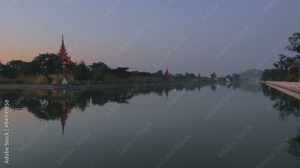 Panoramic view of Royal Palace in Mandalay reflecting in channel water Panoramic view of Royal Palace in Mandalay reflecting in channel water