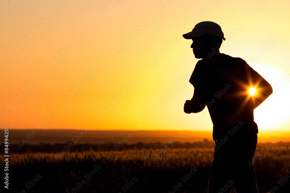 Man silhouette running in the field