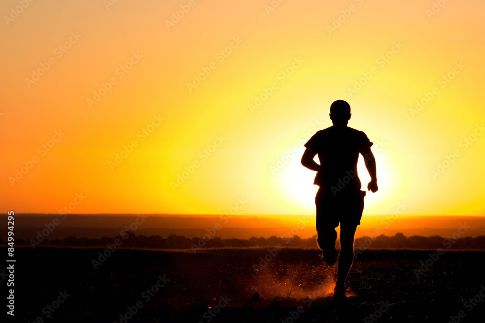 Fototapeta premium a young man running in the field