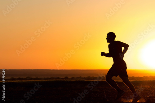 Fototapeta Naklejka Na Ścianę i Meble -  a young man running in the field