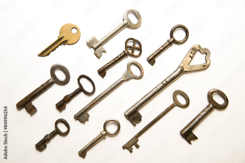 Many old keys to the safe on a white background Many old keys to the safe on a white background