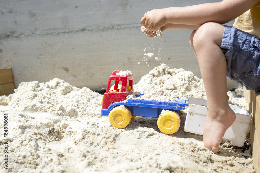 Boy Playing with his Truck Toy at the Beach Sand Boy Playing with his Truck Toy at the Beach Sand