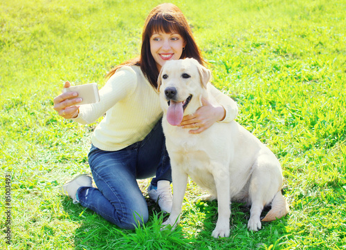 Owner woman with labrador retriever dog taking selfie portrait o © rohappy