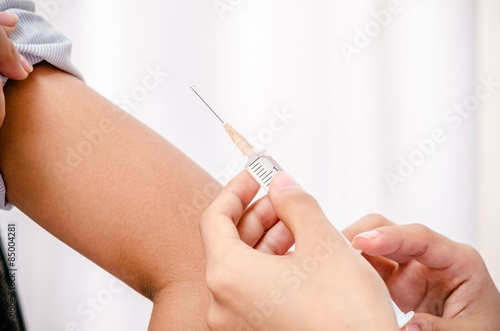 close up of doctor holding syringe for injecting the patient 