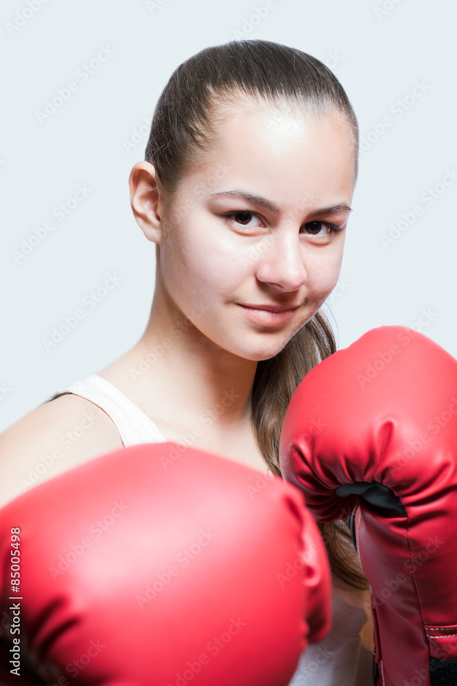 Beautiful young girl in red boxing gloves Beautiful young girl in red boxing gloves