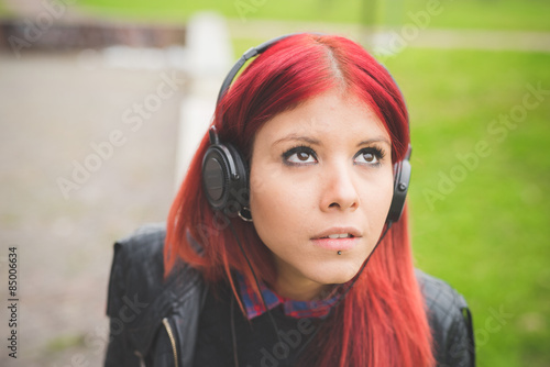 young beautiful red hair venezuelan woman lifestyle listening mu