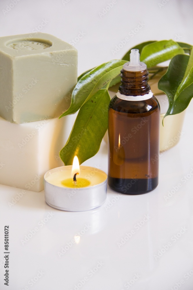 Organic spa setting with natural soap,massage oil and aromatic candle Organic spa setting with natural soap,massage oil and aromatic candle