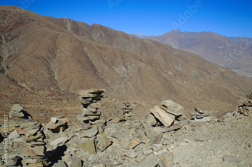 Cairns-stacked stones on Kamba La-mountain pass. Tibet. 1525 photo