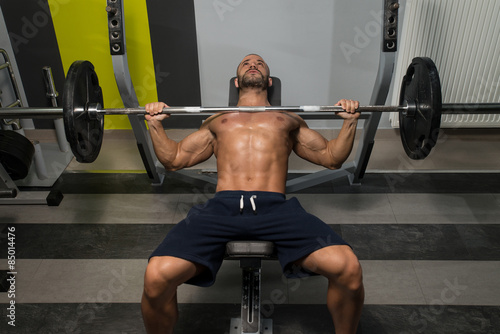 Young Man Doing Bench Press Exercise For Chest