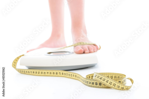 Legs of a woman on weighting machine 