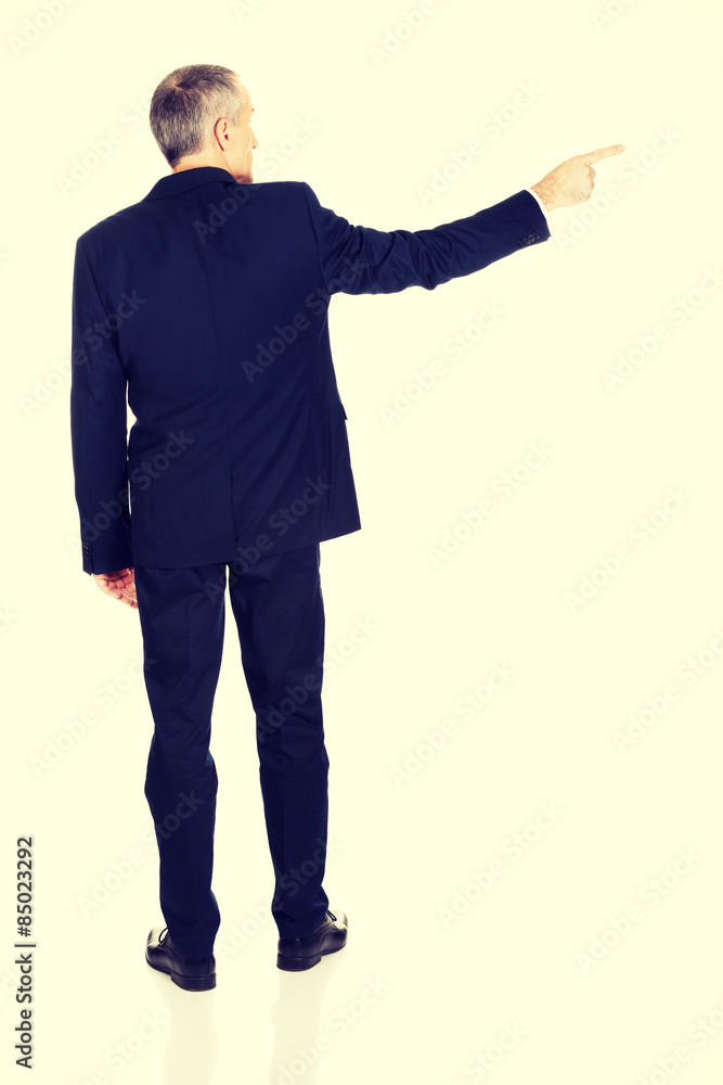 Businessman pointing to the right Businessman pointing to the right