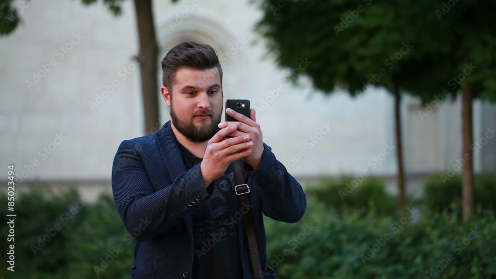 man makes the photo on the phone man makes the photo on the phone