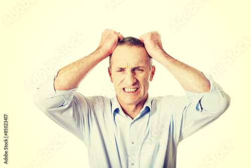 Frustrated man pulling his hair 