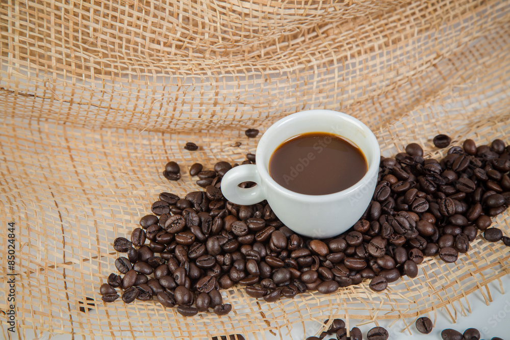 Coffee cup and beans on a white background. Coffee cup and beans on a white background.