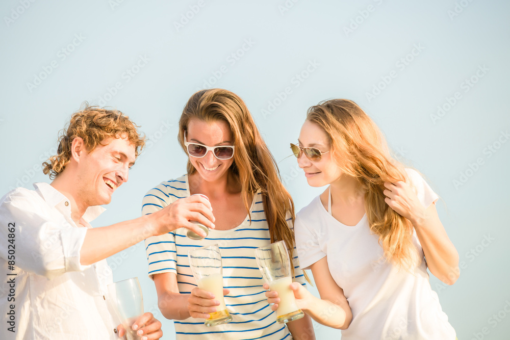 Group of happy young people drinking beer on the beach Group of happy young people drinking beer on the beach