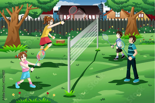 Family playing badminton in the backyard