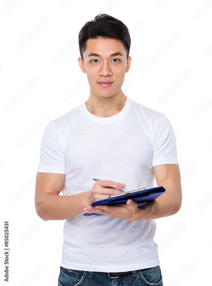 Asian man write on file Asian man write on file