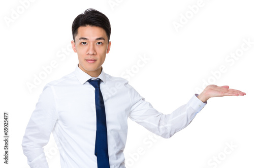 Young businessman with hand showing something