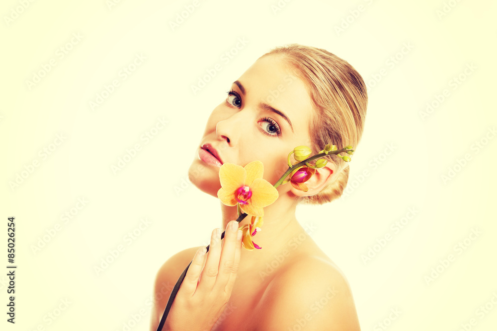 Beautiful spa woman with orange orchid