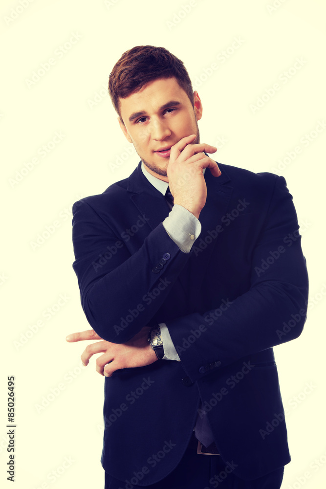 Successful businessman with finger under chin. Successful businessman with finger under chin.