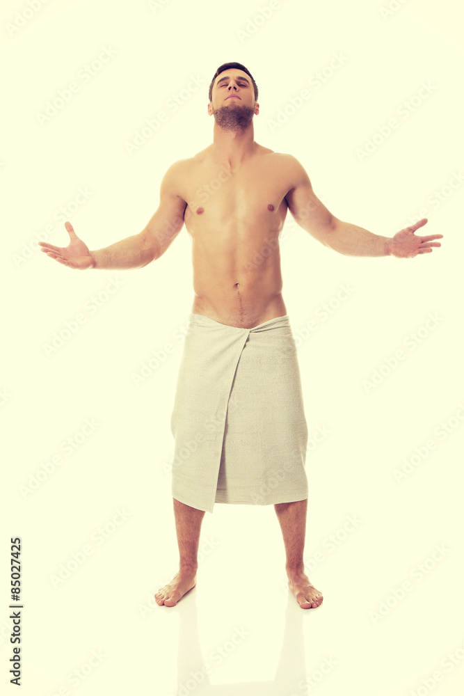 Muscular man wrapped in towel.