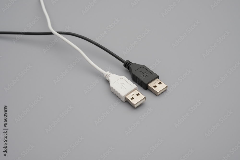 black and white usb cables on grey background black and white usb cables on grey background