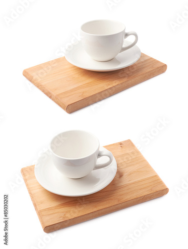 Empty cup on a wooden board isolated