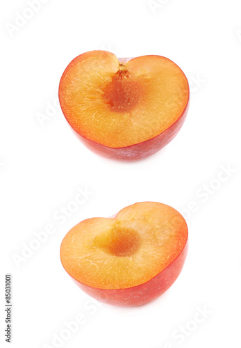 Cut open plum half isolated