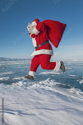 Santa Claus running in the winter
