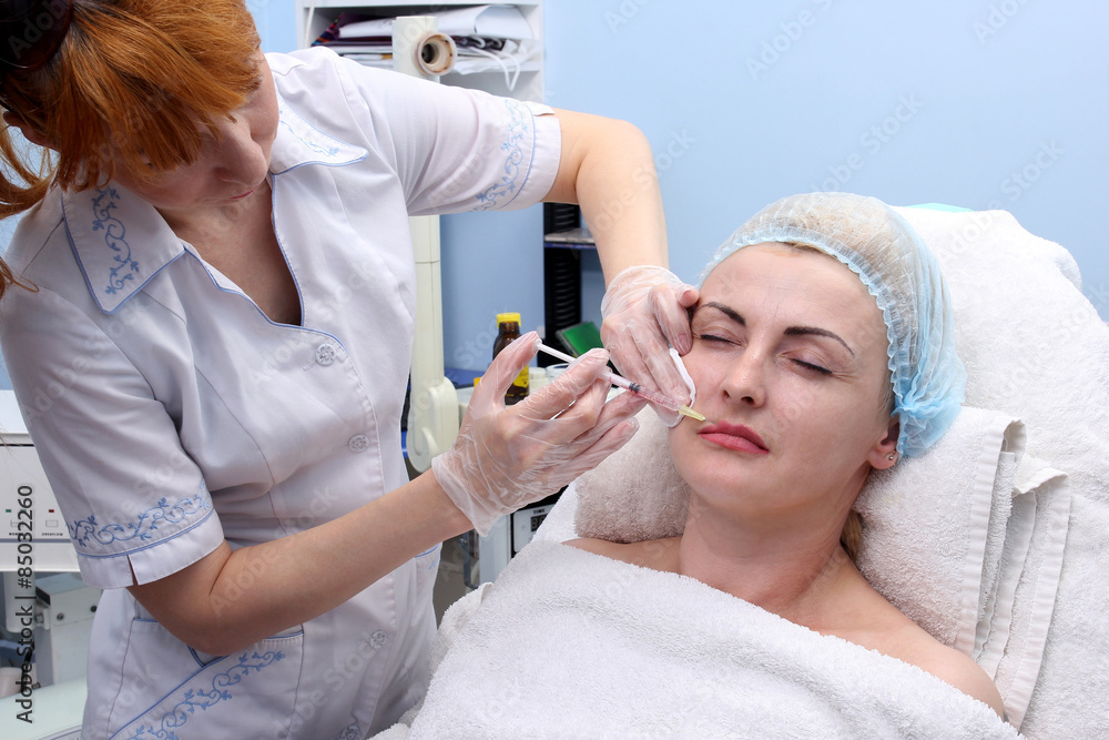 Doctor woman giving botox injections. Doctor woman giving botox injections.