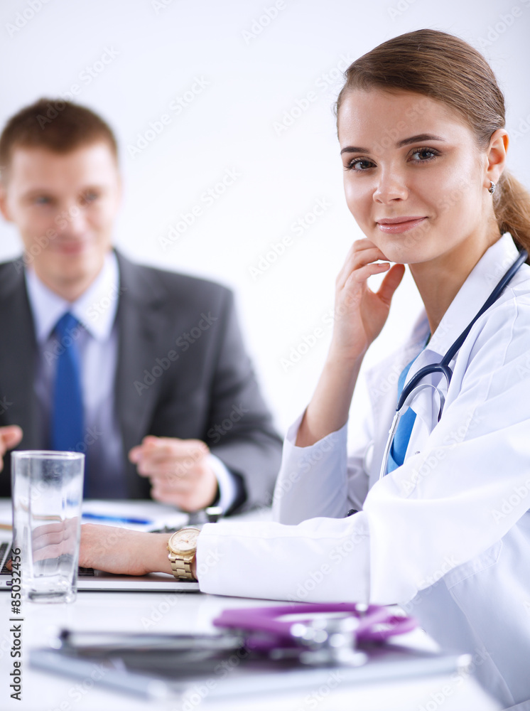 Medical team sitting at the table in modern hospital Medical team sitting at the table in modern hospital